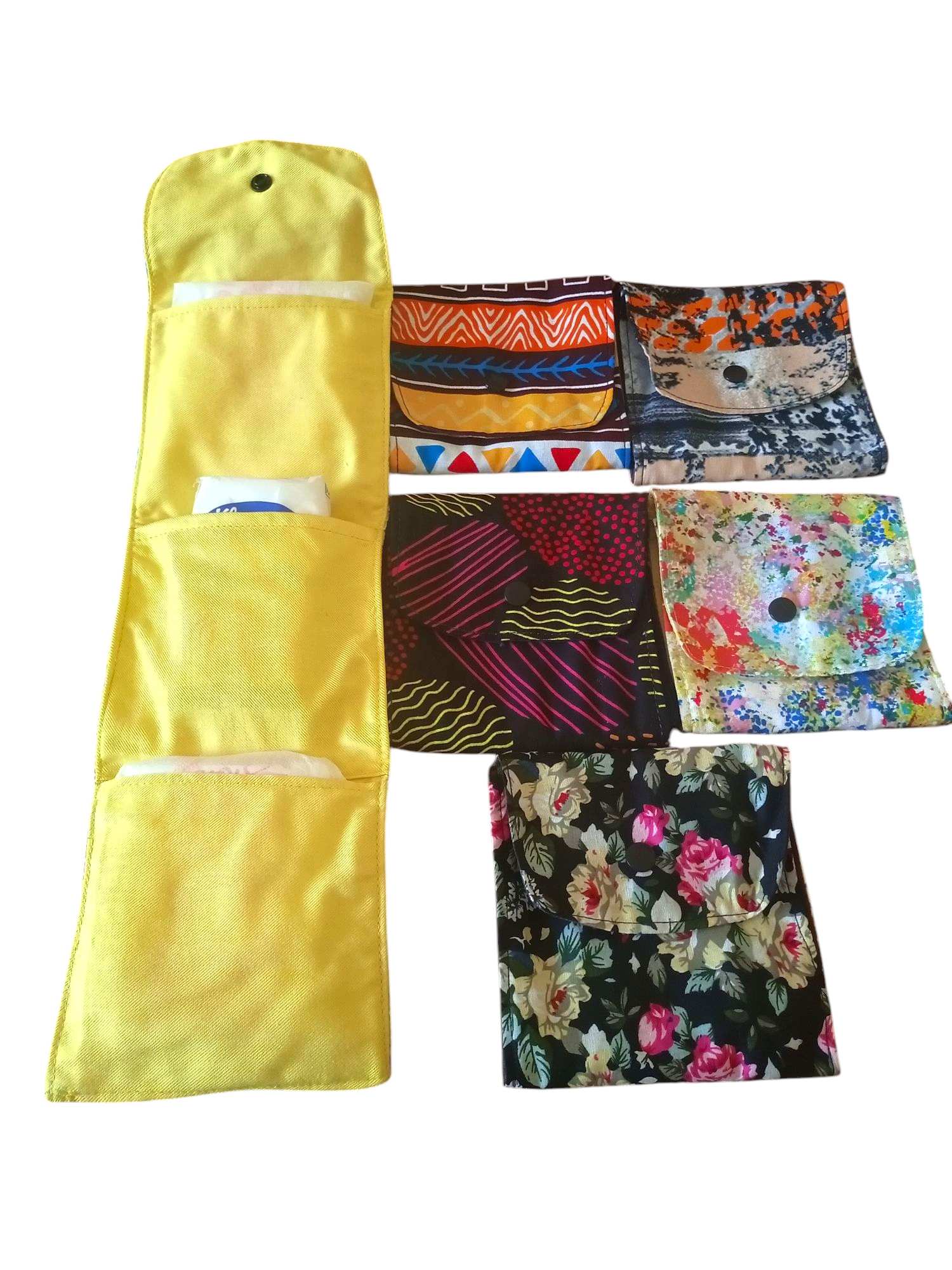 Colorful Handmade Sanitary Pad organizers, Featuring Vibrant Fabric Patterns and Multiple Compartments for storage.