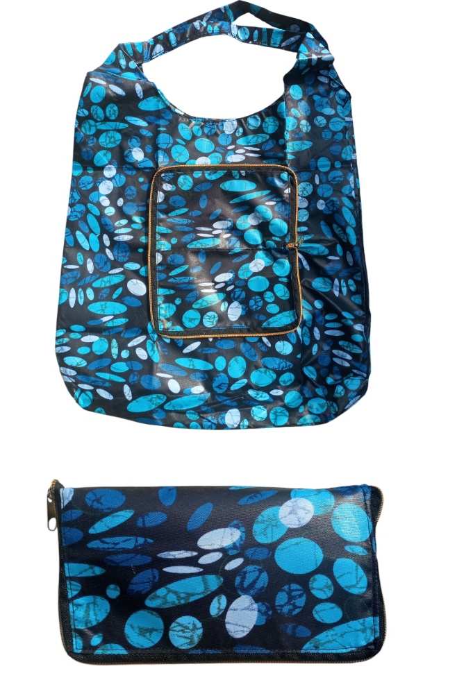 Blue and Black Patterned Reusable Shopping Bag Folded into a Zippered Pouch for Compact storage.